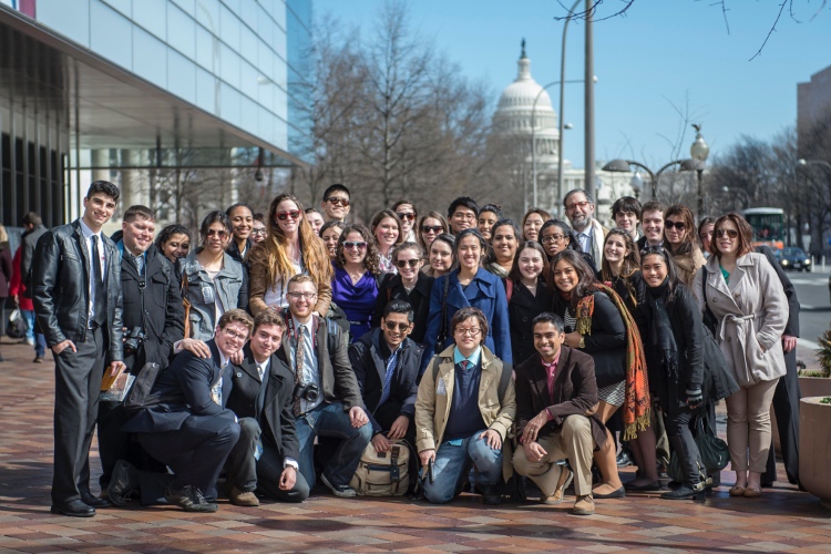 US Capitol in the background. Large group of happy college students posing for photo